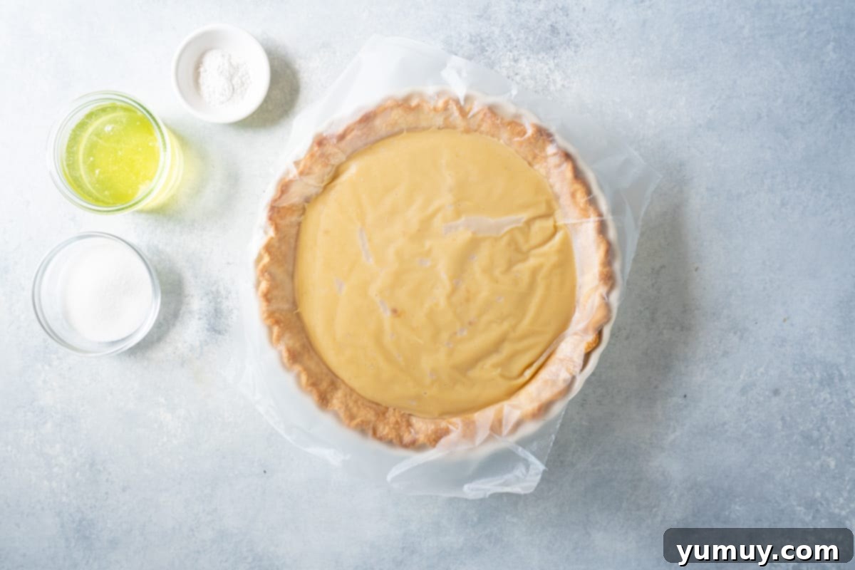 Golden Butterscotch Delight 21 A butterscotch pie with plastic wrap directly covering the pudding filling to keep it warm and prevent skin formation.