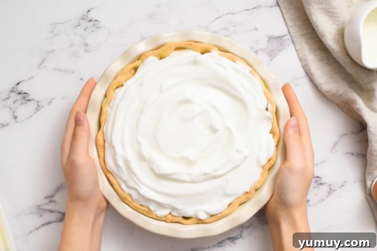 Golden Butterscotch Delight 23 A glorious butterscotch pie, freshly topped with voluminous, light meringue, ready for baking.