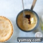 Golden Butterscotch Delight 7 Stirring butter and vanilla into the butterscotch filling after removing from heat.