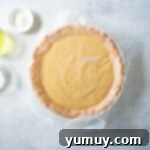 Golden Butterscotch Delight 9 Covering the warm butterscotch pie filling with plastic wrap to prevent skin formation.