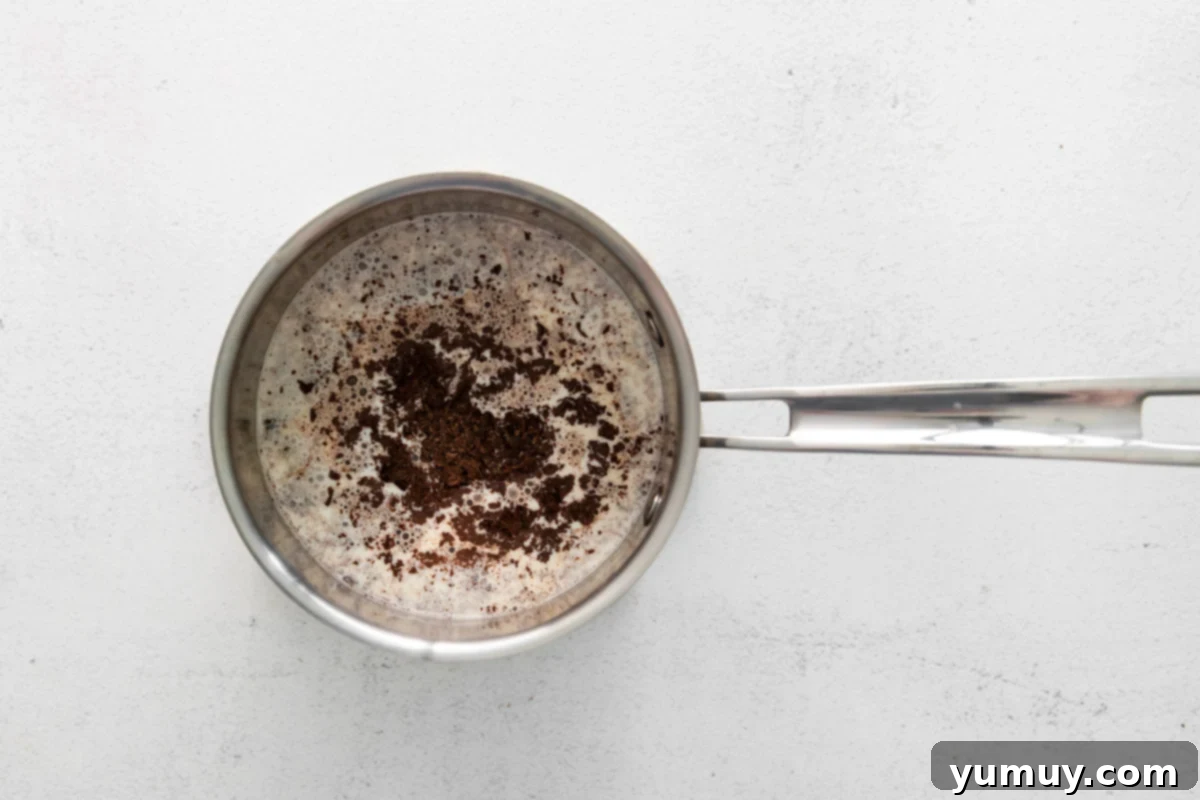 Decadent Chocolate Custard 10 a frying pan with coffee in it on a white background.