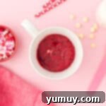overhead view of red velvet mug cake on a pink table