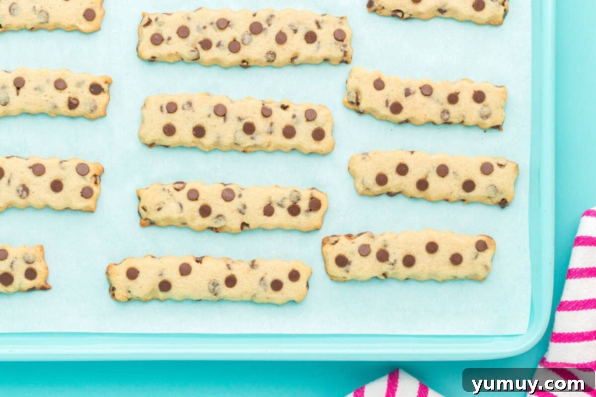 Golden Cookie Fries with Chocolate Chips 17 Golden brown Chocolate Chip Cookie Fries fresh out of the oven, cooling on a baking sheet.