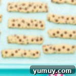 Golden Cookie Fries with Chocolate Chips 10 Golden brown Chocolate Chip Cookie Fries fresh out of the oven, cooling on a baking sheet.