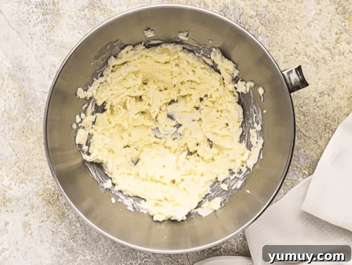 Decadent Chocolate Cream Cheese Frosting 6 whipped butter and cream cheese in a stand mixer bowl.