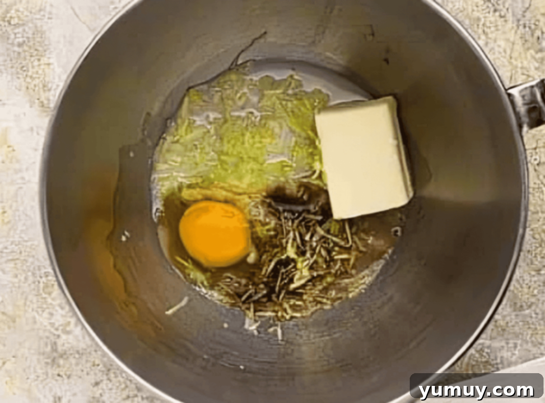 Decadent Chocolate Zucchini Cupcakes 13 wet ingredients for zucchini cupcakes in a stainless mixing bowl.