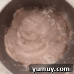 Decadent Chocolate Zucchini Cupcakes 6 dry ingredients for chocolate cupcakes in a stainless mixing bowl.