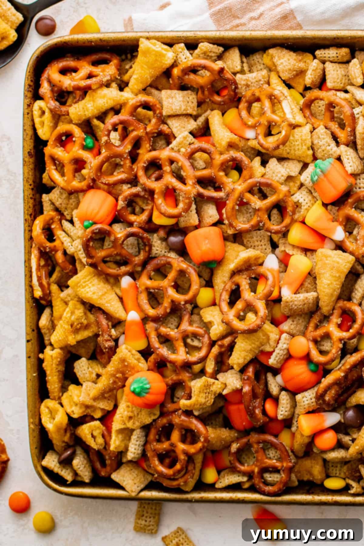 partial overhead view of halloween chex mix on a baking sheet.