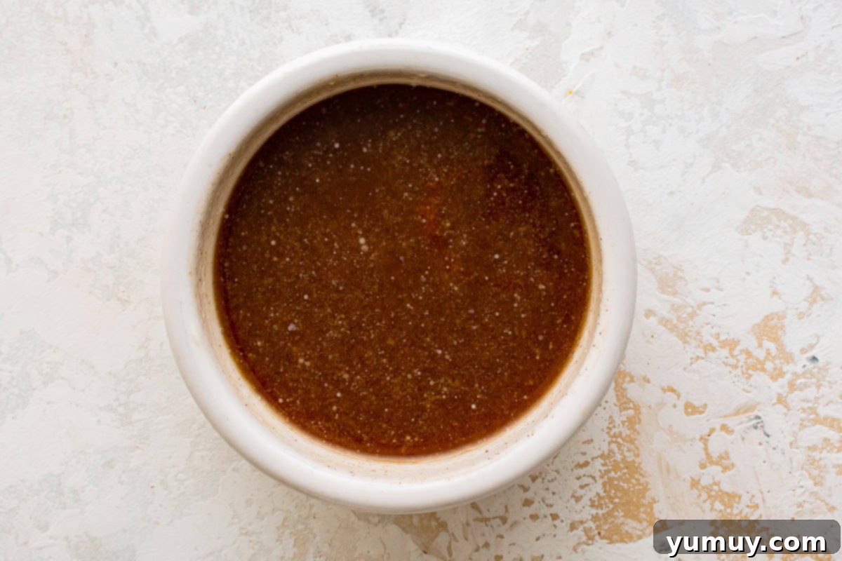 melted butter, brown sugar, and pie spice in a white bowl.