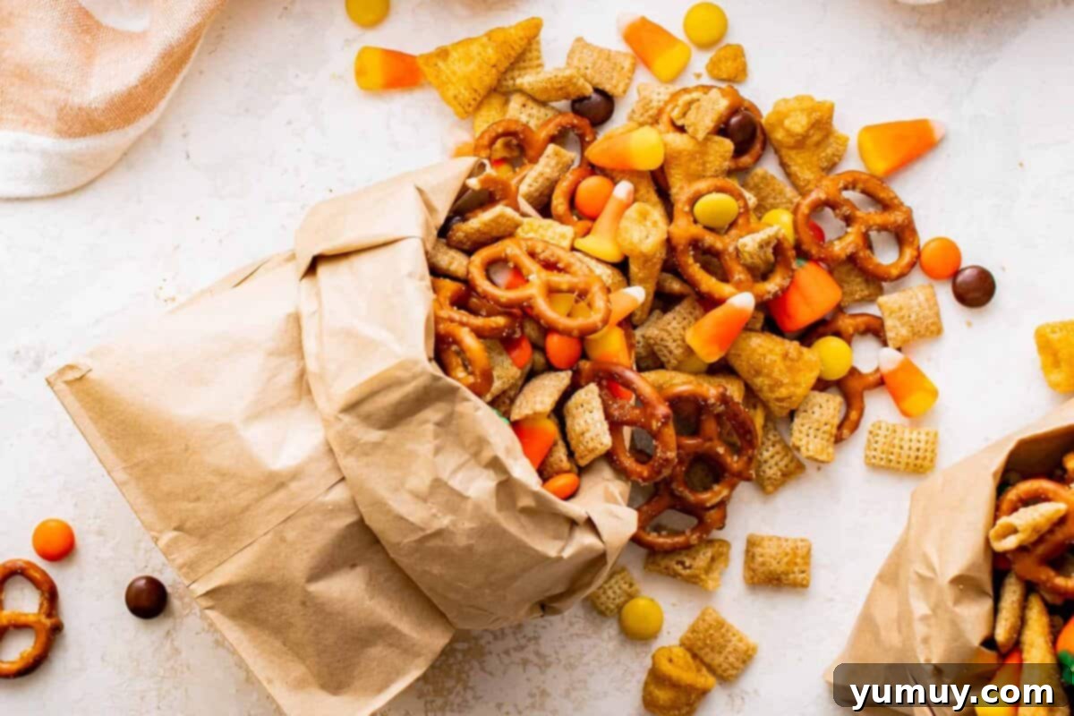 overhead view of halloween snack mix spilling out of a paper bag.