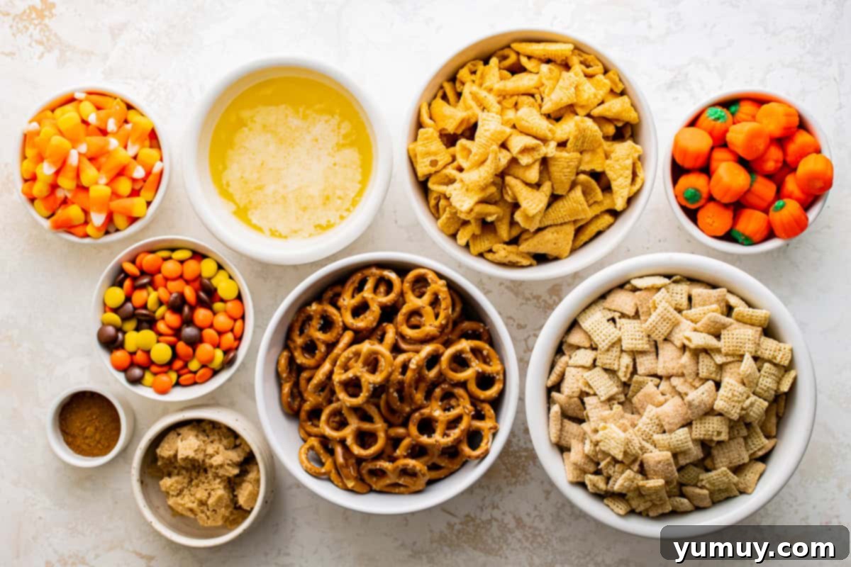 Ingredients for halloween chex mix arranged in bowls.