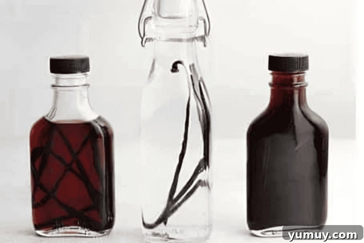 Jars of homemade vanilla extract in various stages of infusion, showcasing different shades of brown.