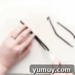 Slicing vanilla beans lengthwise with a knife