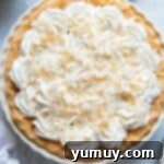Creamy Coconut Bliss 10 overhead view of a whole coconut cream pie with whipped topping
