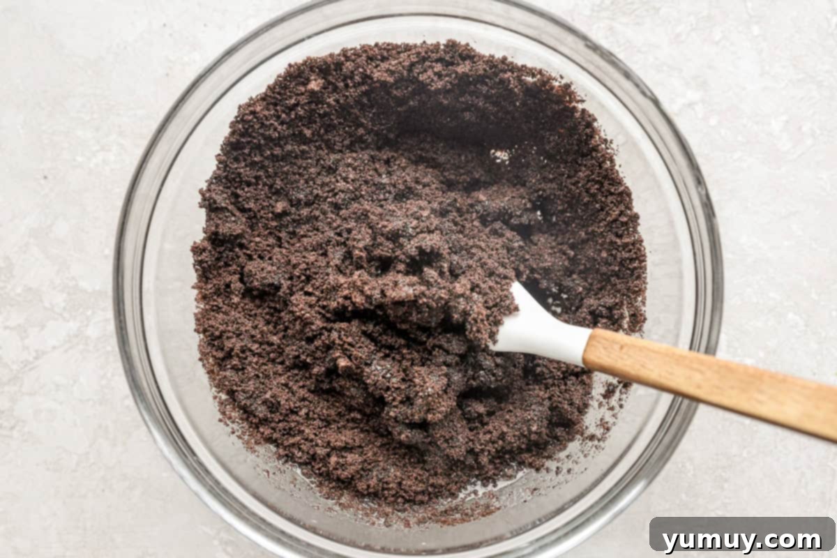 Combining Oreo crumbs to make a crust.