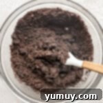 Combining Oreo crumbs to make a crust.