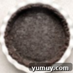 Oreo pie crust pressed into a pie dish.