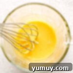 Whisking egg in a glass.