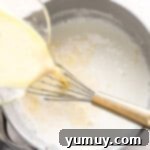 Pouring cream into a pot.