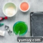 Bowls of red and green Jell-O mixture with unflavored gelatin ready to be combined, showcasing vibrant colors.