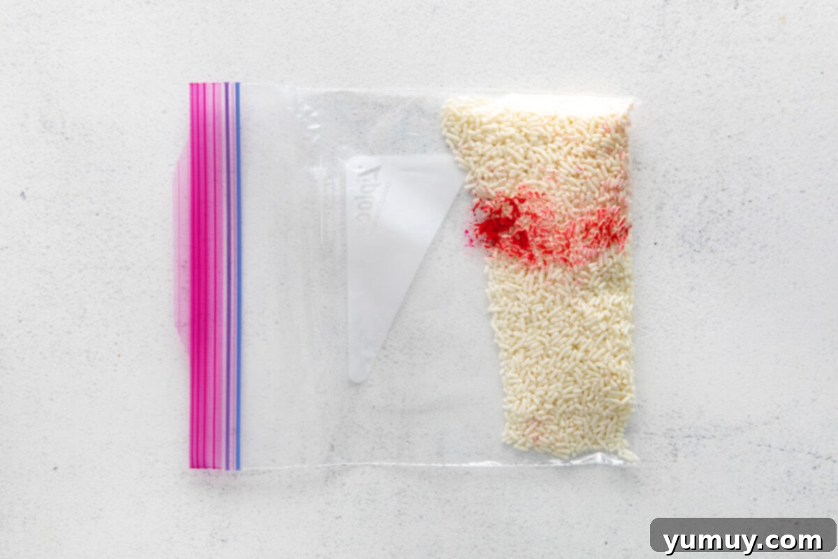 Crafting Custom Colored Sprinkles 8 A resealable plastic bag containing white sprinkles and a drop of food dye, demonstrating the gentle massaging technique for even color distribution.