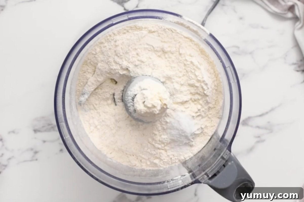 Flour, salt, and sugar combined in a food processor.
