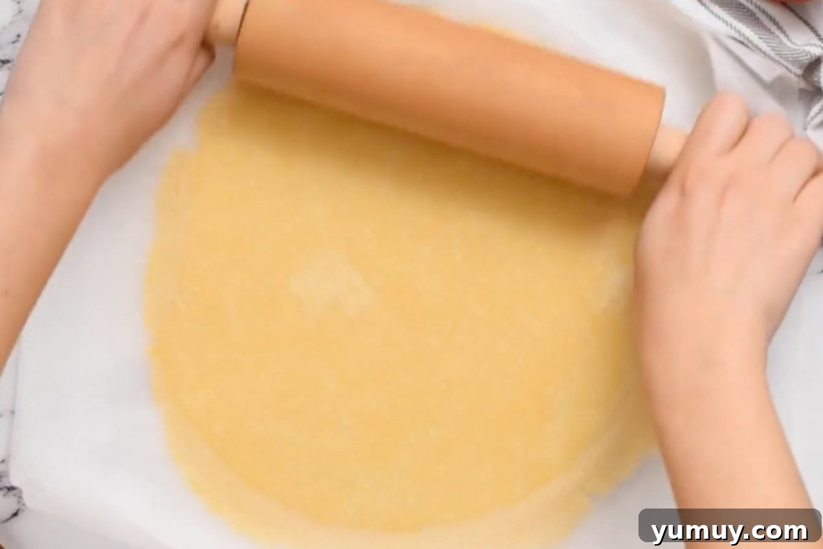 Rolling out pie crust dough.