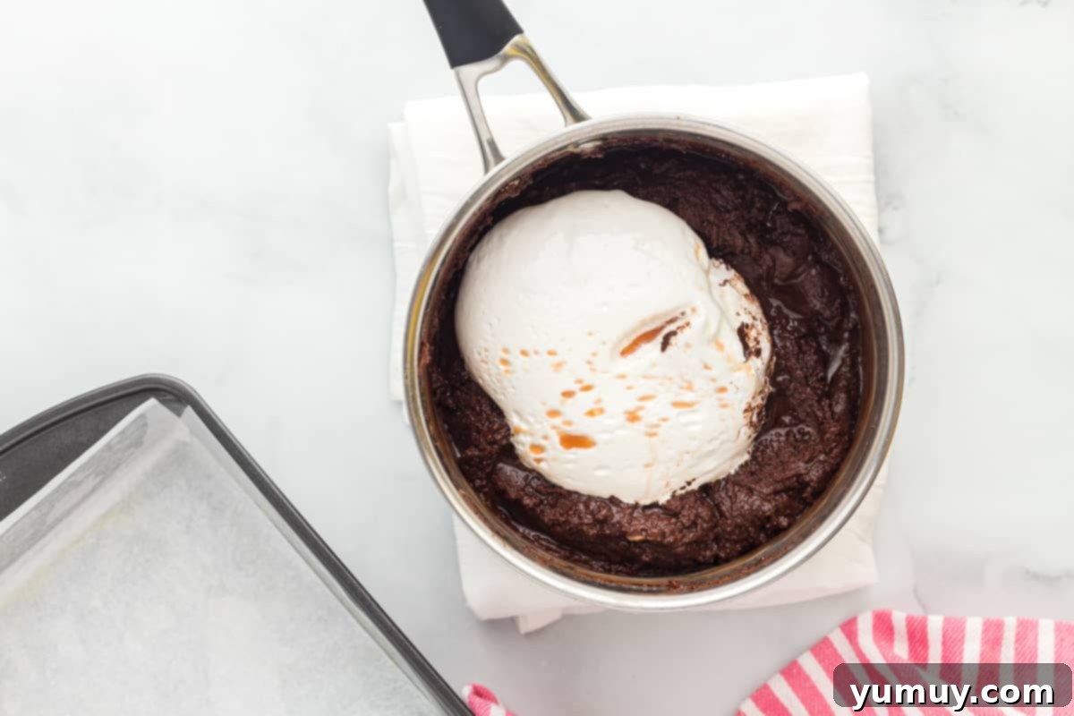 Dreamy Marshmallow Fudge 11 marshmallow fluff being mixed into fudge