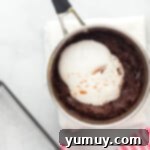 Dreamy Marshmallow Fudge 7 marshmallow fluff being mixed into fudge