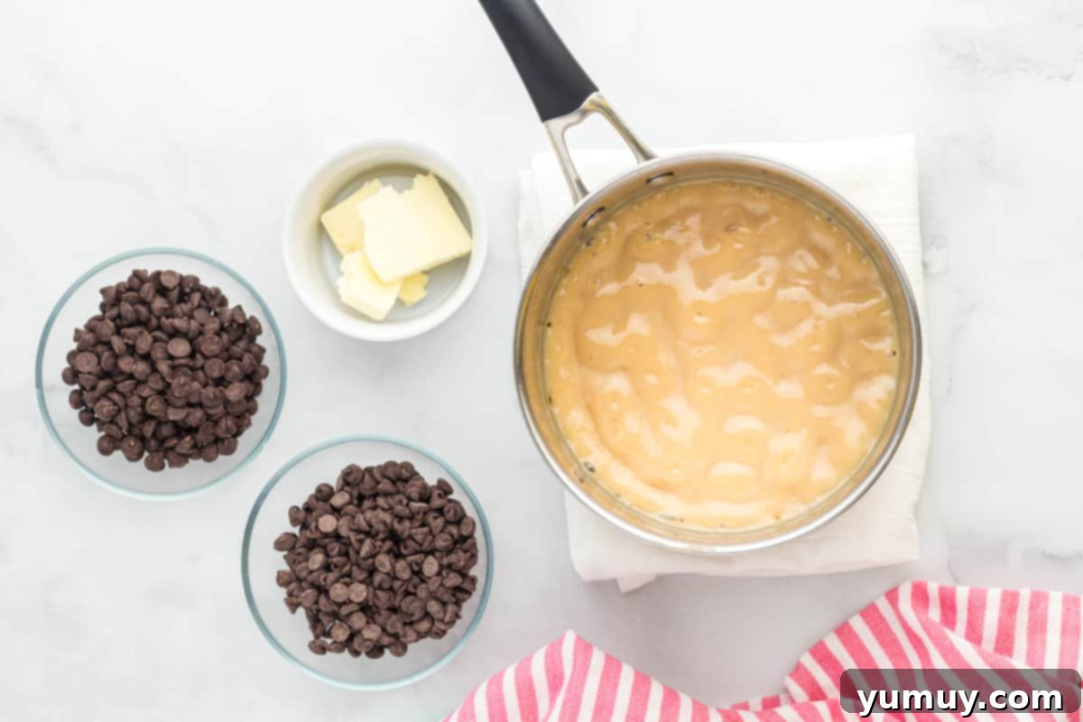 Dreamy Marshmallow Fudge 9 chocolate chip cookie dough ingredients on a marble countertop.