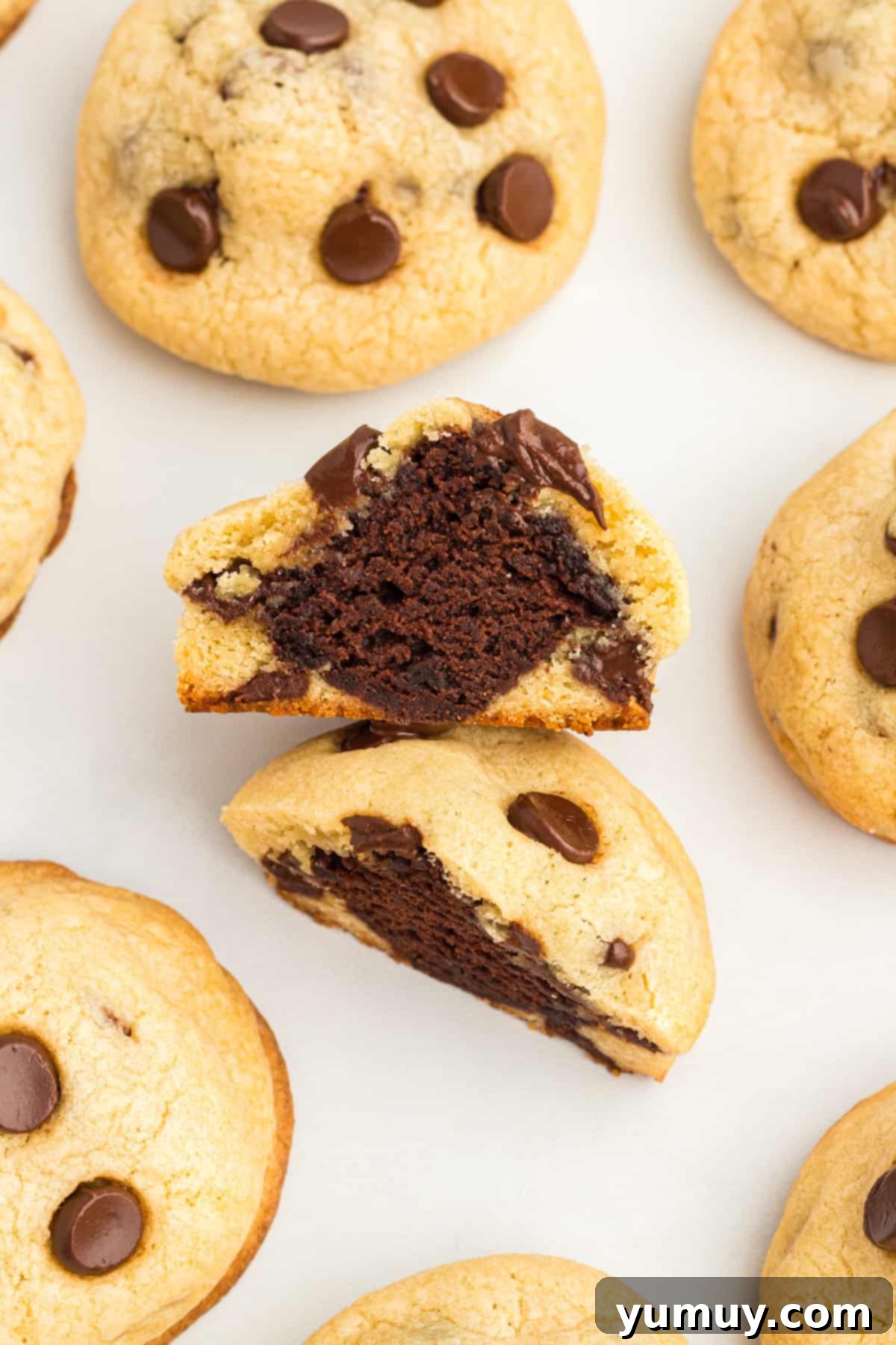 chocolate chip cookie cut in half to reveal a brownie at the center