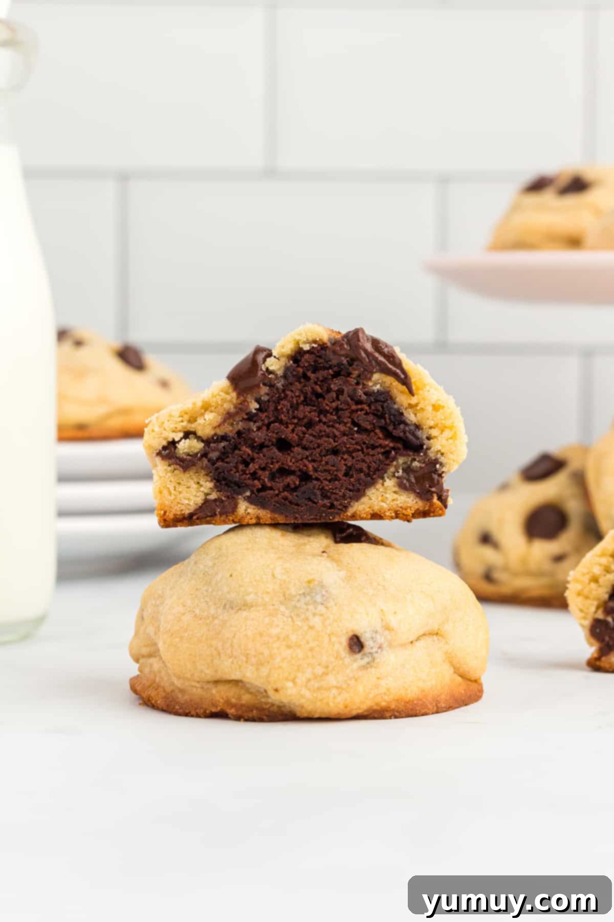 brownie stuffed chocolate chip cookie cut in half to show the middle