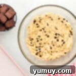 a bowl of chocolate chip cookie dough next to a smaller bowl of brownies cut into cubes