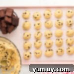 chocolate chip cooke dough balls and cubes of brownies arranged on a baking tray