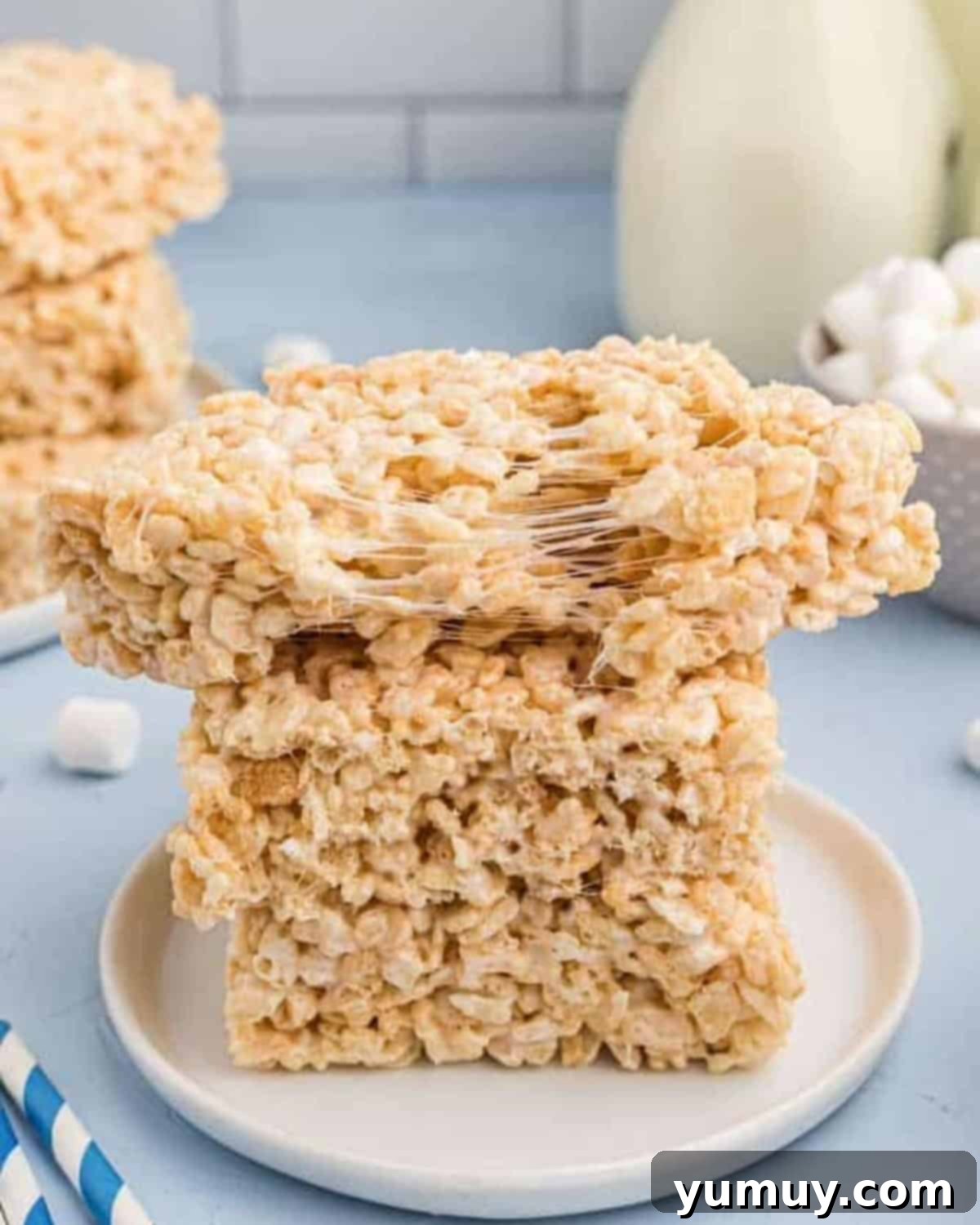 Crispy Marshmallow Squares 2 A gooey split Rice Krispie treat on top of a stack of 2 treats, showcasing its delightful texture.