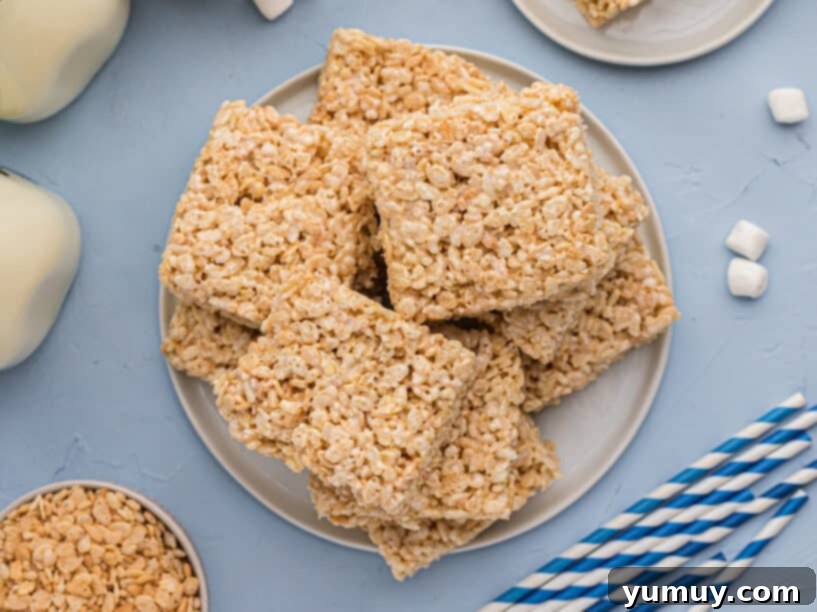 Crispy Marshmallow Squares 3 Overhead view of a plate of perfectly golden, homemade Rice Krispie treats.