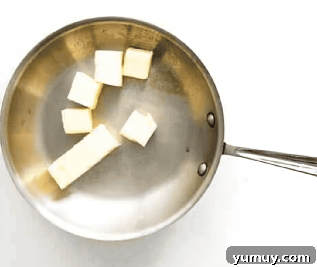The Secret to Golden Brown Butter 8 partially cubed butter in a frying pan.