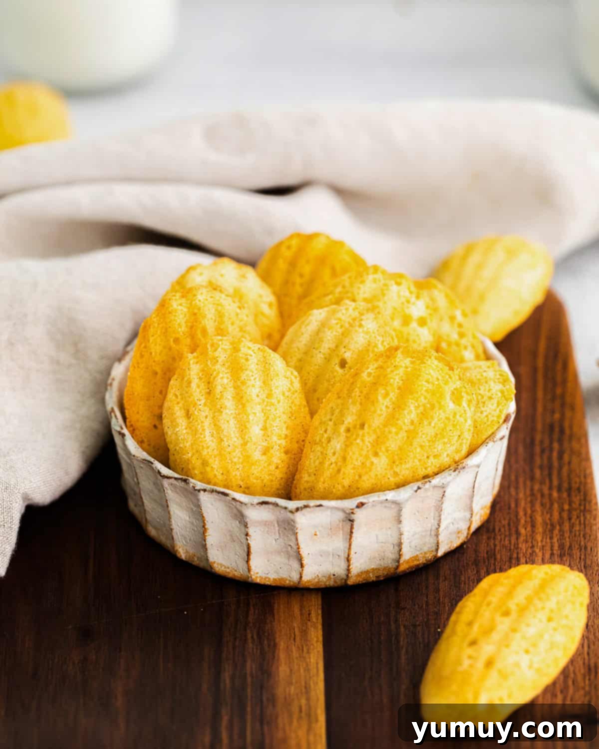 Delicate French Shell Cakes 2 madeleine cookies in a small white dish.