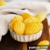 Delicate French Shell Cakes 4 madeleine cookies in a small white dish.