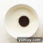 Oreo cookie in a bowl of white chocolate