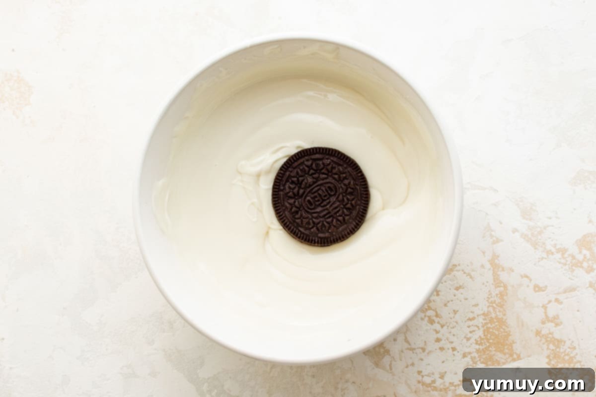 Oreo cookie in a bowl of white chocolate