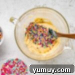 Cake Batter Confetti Cookies 6 Rainbow sprinkles being folded into the cookie dough mixture.