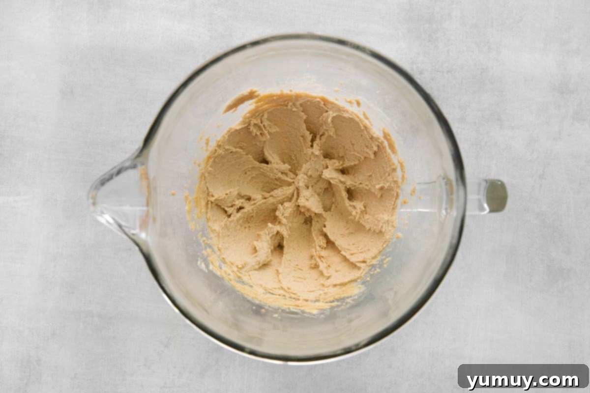 Mixing egg and vanilla into the creamed butter and sugar