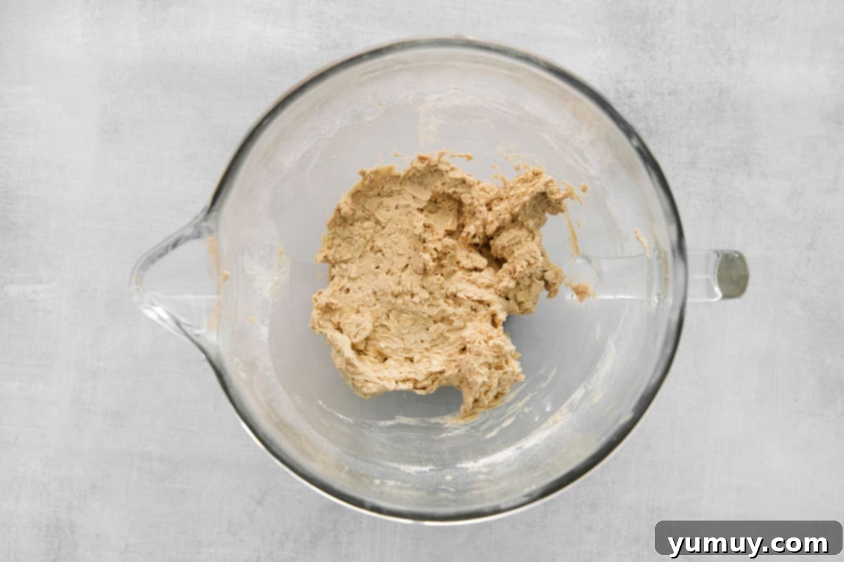 Adding dry ingredients like oats, flour, and baking soda to the cookie dough