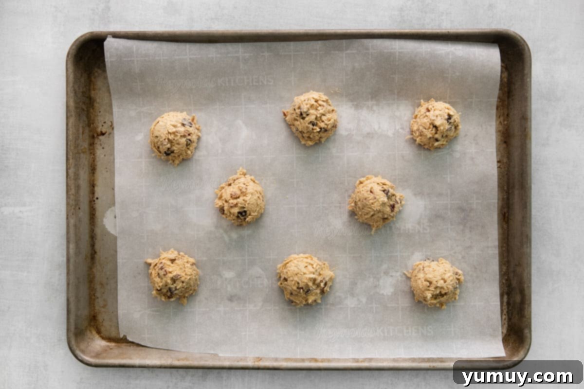 Portioned cowboy cookie dough balls on a baking tray ready for the oven