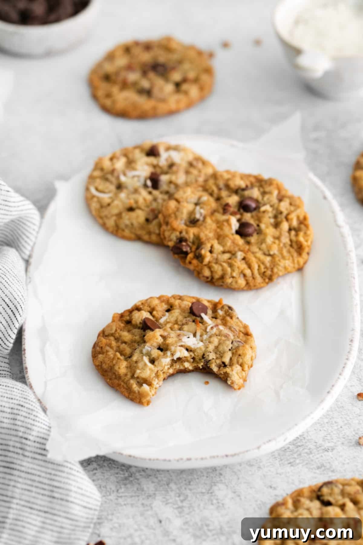 Freshly baked cowboy cookies on a white serving plate, highlighting their delightful texture