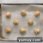 balls of cookie dough perfectly spaced on a parchment-lined baking tray