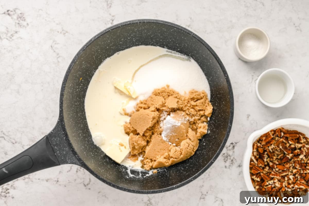 All praline ingredients, including sugars, cream, butter, and baking soda, in a large pot before heating.