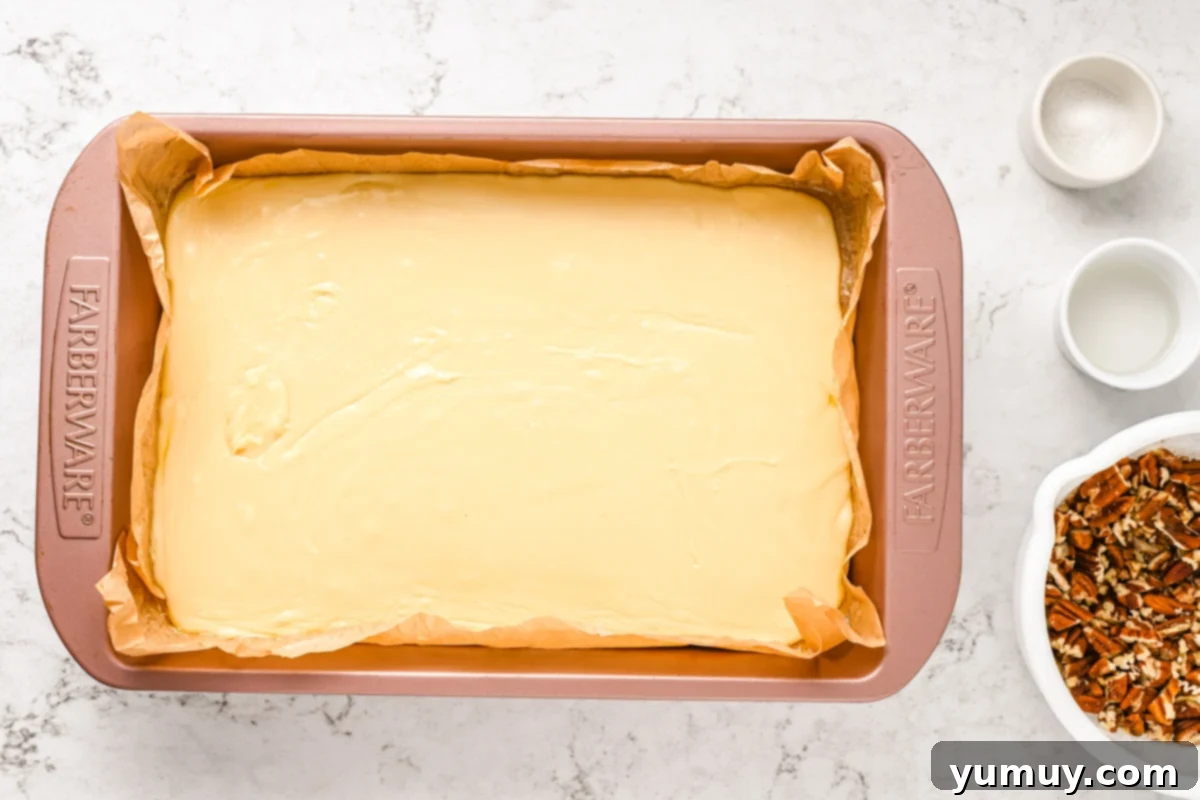 The smooth, melted white chocolate fudge base poured and leveled into the baking pan.