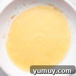 a frying pan with a yellow batter in it.